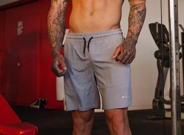 man wearing gray drawstring shorts with pockets