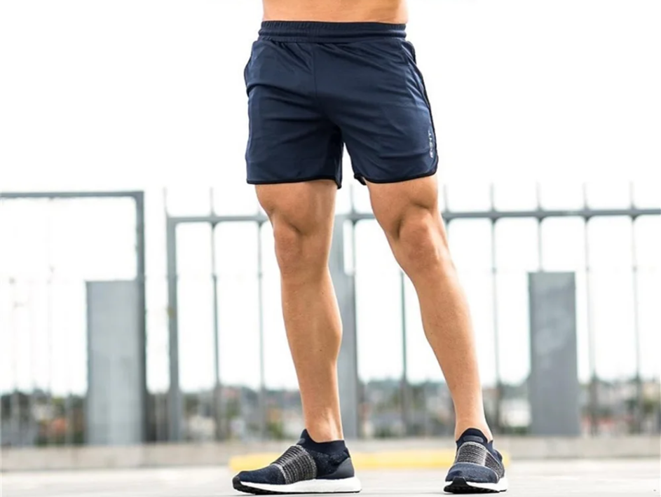 man outside wearing navy blue shorts with drawstring and pockets