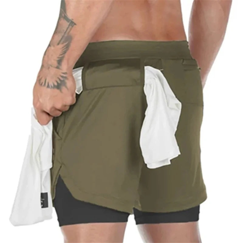 man wearing army green shorts with pockets and towel holder for working out and cardio