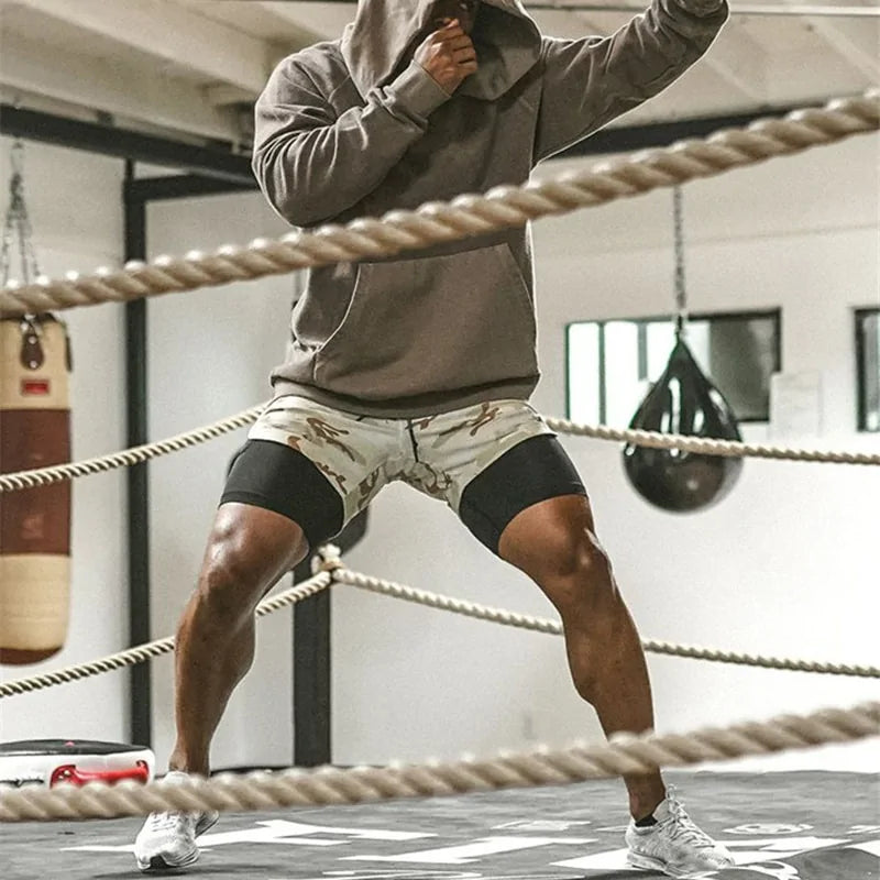 man in a boxing ring shadowboxing with tan camo shorts 